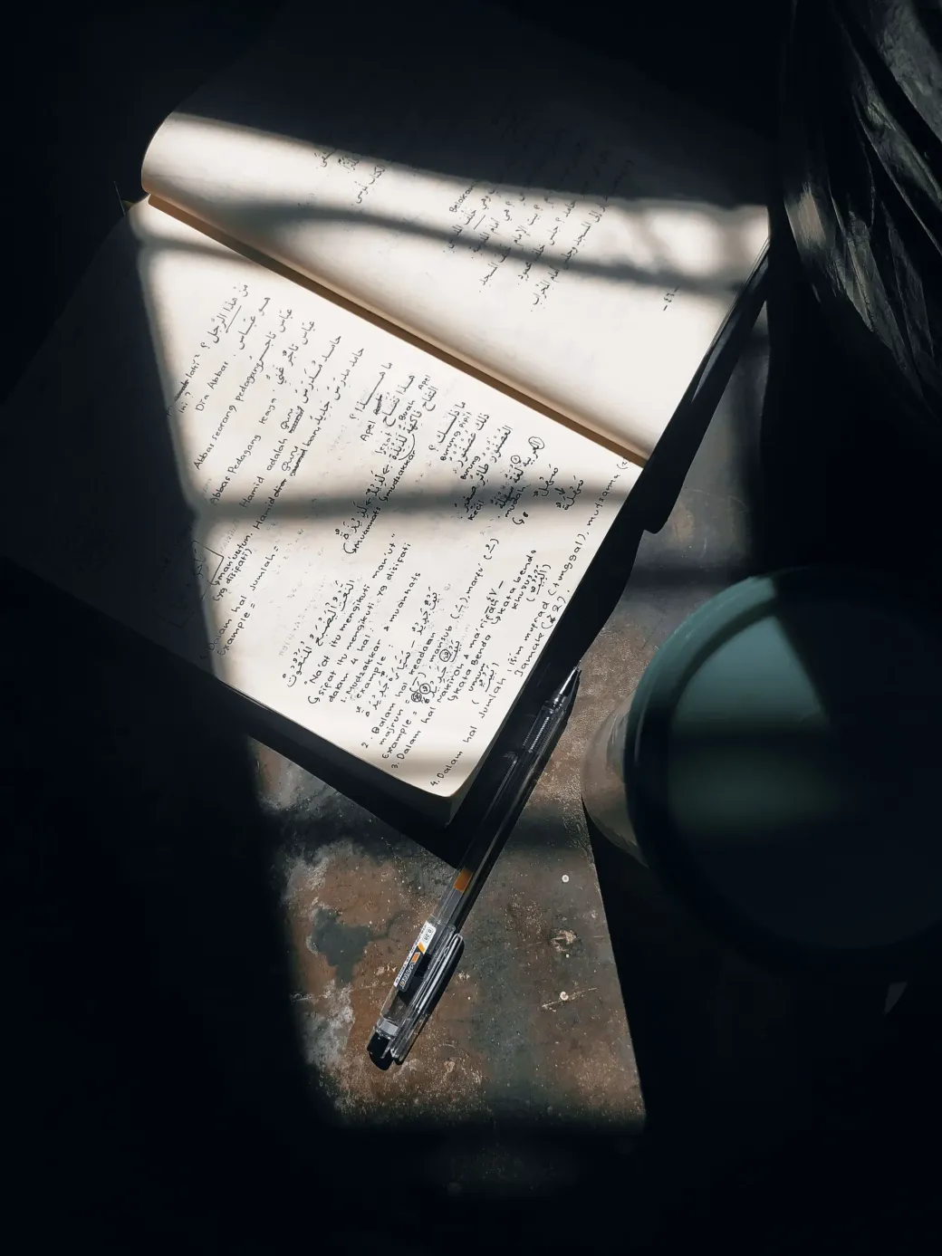 A worn, dirt-smudged paper notebook on a truck steering wheel