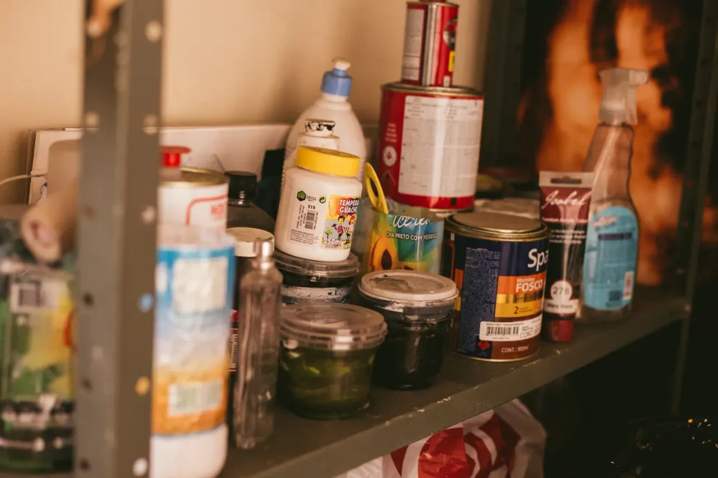 A cluttered supply shed with disorganized chemical containers